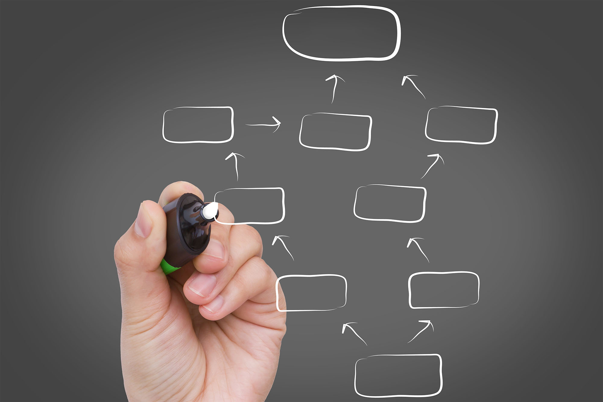 Businessman hand drawing a social network scheme on a whiteboard